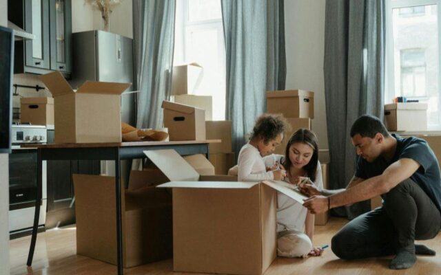 Family preparing for furniture storage with moving boxes in their home